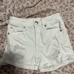 White mid rise jean shorts.